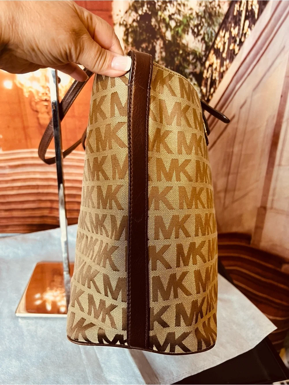 Michael Kors Jet Set tote features monogram canvas, contrasting leather straps